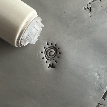 Personalized pottery stamp with initials and sun