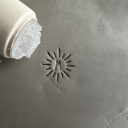 Personalized pottery stamp with initials and minimalist sun