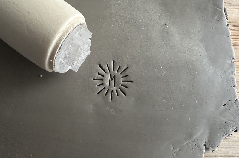 Personalized pottery stamp with initials and minimalist sun