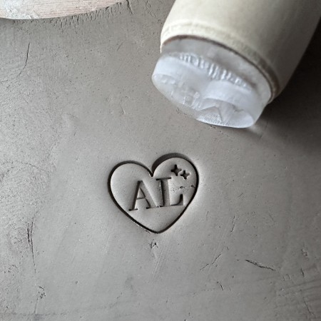 Personalized pottery stamp with initials and starry heart