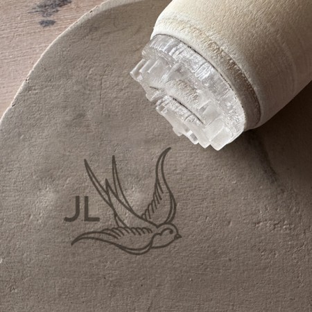 Personalized pottery stamp with initials and swallow
