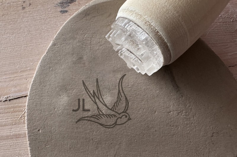 Personalized pottery stamp with initials and swallow
