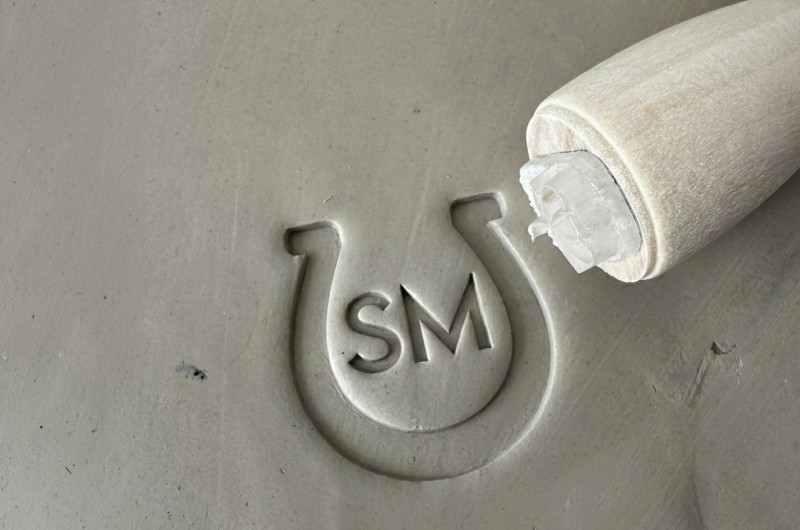 Personalized pottery stamp with initials and horseshoe