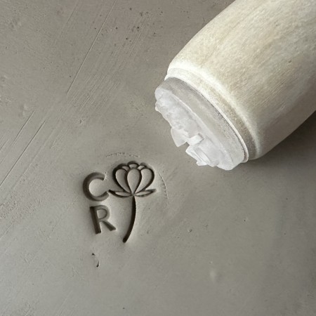 Personalized pottery stamp with initials and flower
