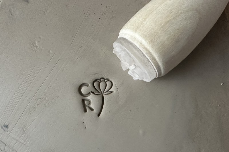 Personalized pottery stamp with initials and flower