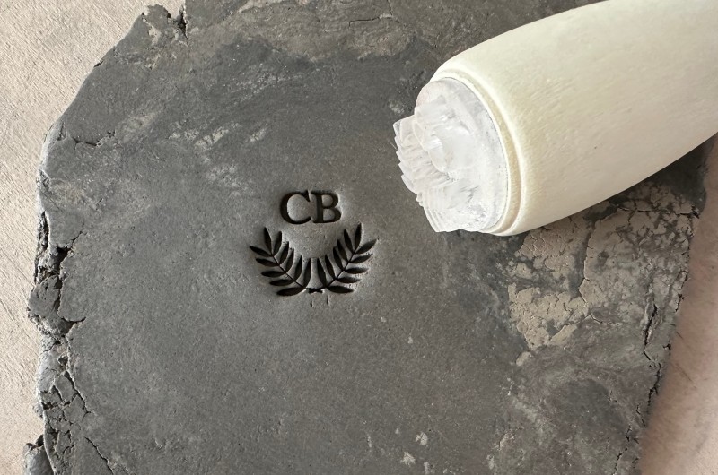 Personalized pottery stamp with initials and laurel wreath