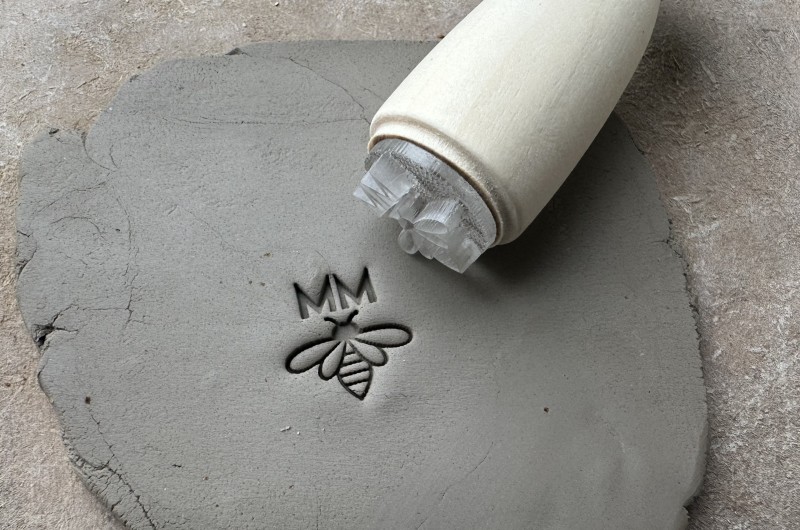 Personalized pottery stamp with initials and bee