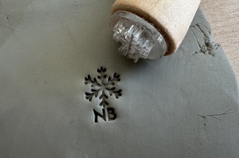 Personalized pottery stamp with initials and snowflake